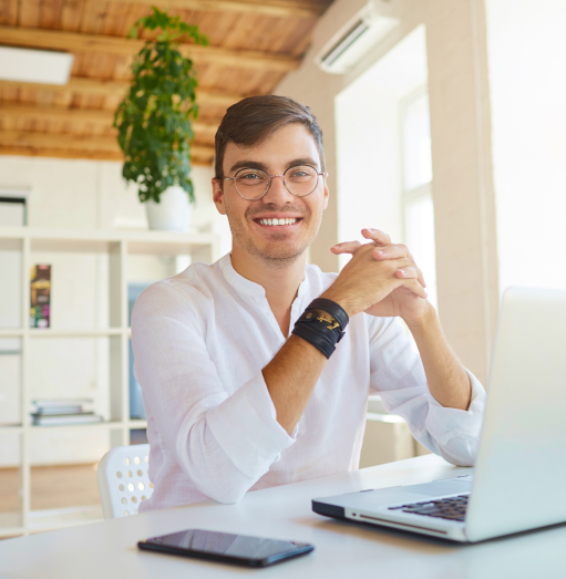 Man in white shirt smiling near laptop What is a peo?