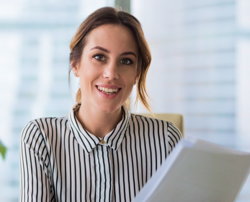 Business woman smiling at camera in office What is a PEO?
